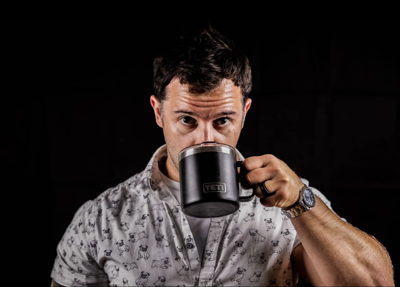 Brandon Morey, who built Ch4pter, drinking coffee from a black mug